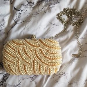 Kata Landy pearl clutch with removable strap